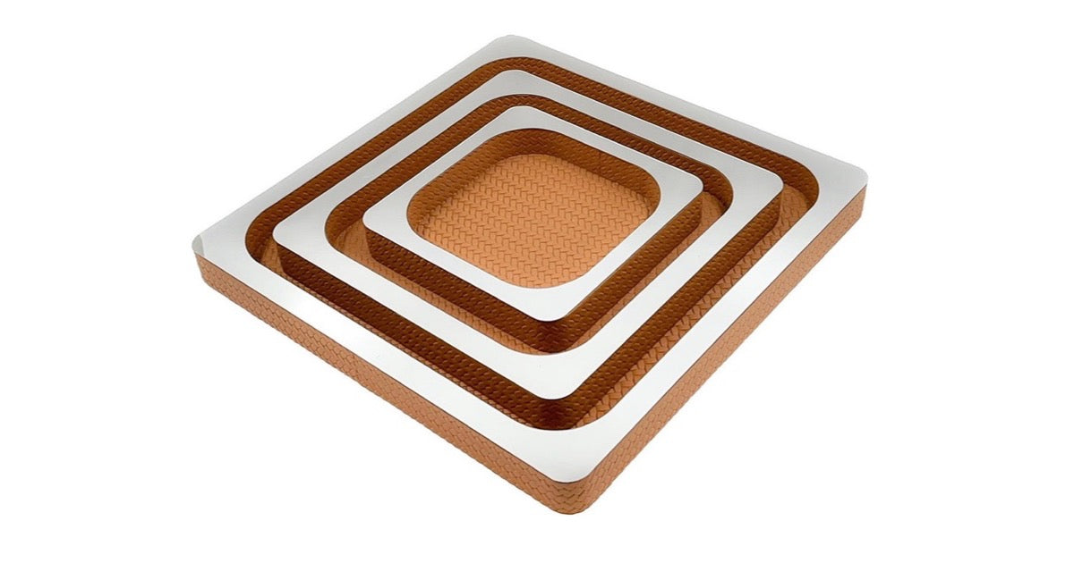 Mirror-top nesting leather tray set in Tan: square leather trays with mirrored tops, nested one inside another on a white background.