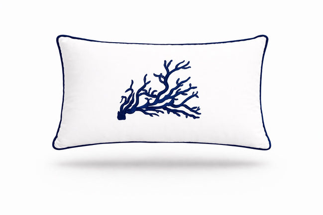 Navy coral embroidered across a white 35 x 55 cm outdoor cushion trimmed in navy piping