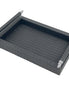 Black 31 × 21 cm serving tray from above left, leather-wrapped handle rails raised on polished steel posts