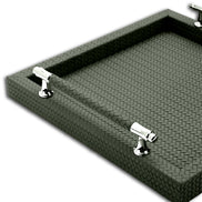 Corner of the 36 x 36 cm tray, a polished steel handle mount seated through the woven leather rim wall