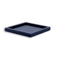 Navy tray from above right, the well shadowed inside four unbroken leather walls