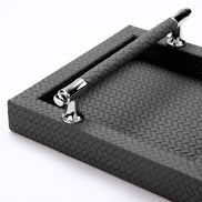 Detail of the leather-wrapped handle bar above the herringbone weave running across the base
