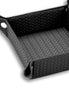 Black 15 × 15 cm valet tray close from above, a polished press stud drawing up the near corner