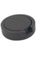Round black leather coaster holder seen from above, a finger notch cut into the woven-embossed wall