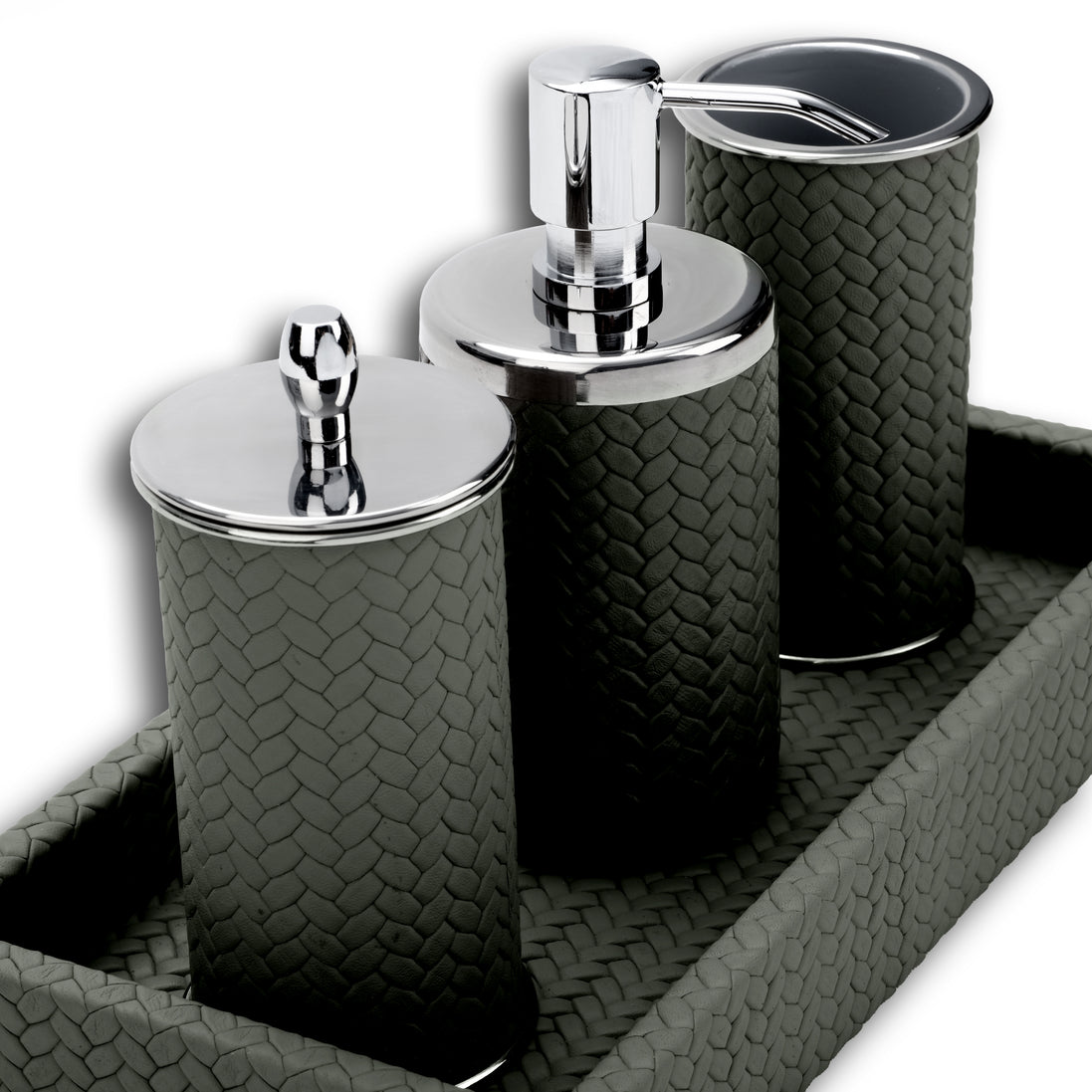 Grey woven leather bathroom set close up: chrome pump, lidded jar and tumbler standing on the tray