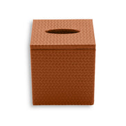 Terracotta tan cover, the leather weave catching light along the lid overhang