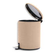 Pale cream leather bin seen in profile, lid raised and the pedal linkage exposed at the base