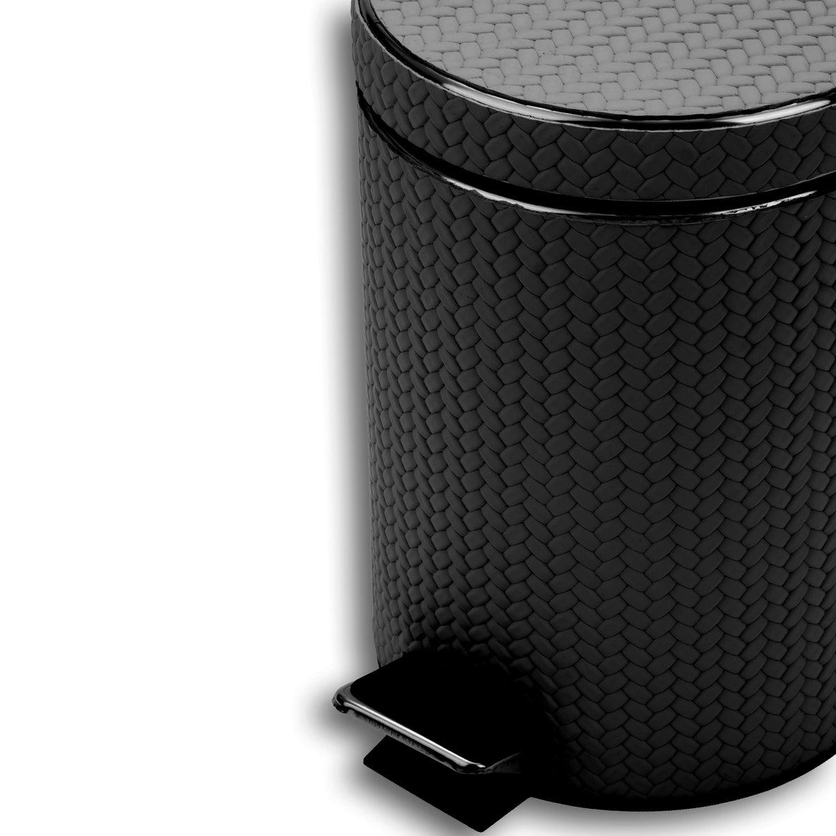 Close on the black bin's lid and upper body, woven-embossed full-grain leather at full scale above the chrome pedal plate
