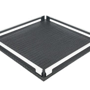 Black 37 × 37 cm square tray from above left, two full-length steel rails framing the woven-embossed leather floor