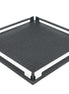 Black 37 × 37 cm square tray from above left, two full-length steel rails framing the woven-embossed leather floor