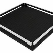 The black 37 cm tray seen almost flat on, one corner toward the viewer, steel rails bounding the dark leather field