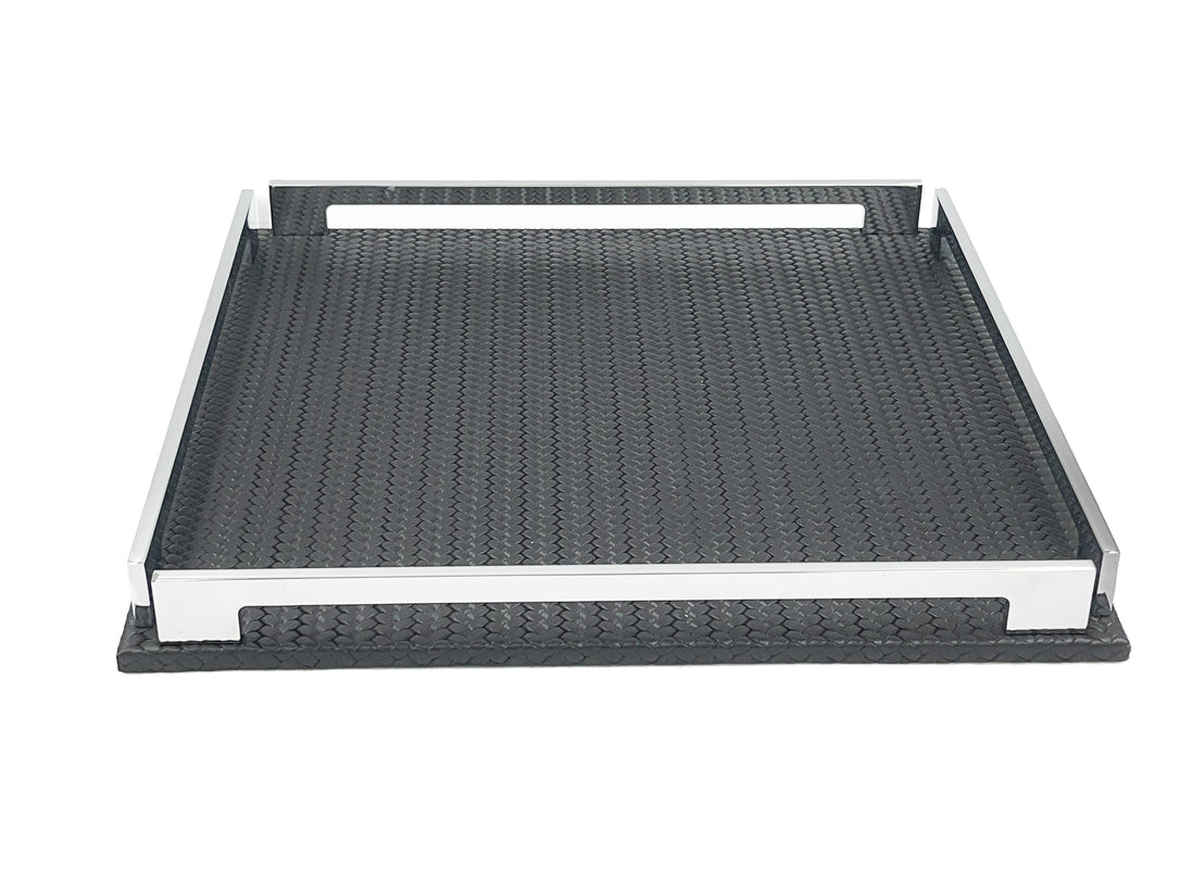 Low view of the black 37 cm tray, front steel rail across the frame and the leather floor receding behind