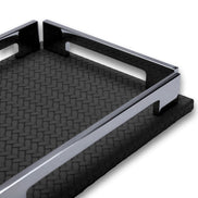 Low view along the long side of the black tray, polished steel rail and the notch cut into the 1 cm leather base