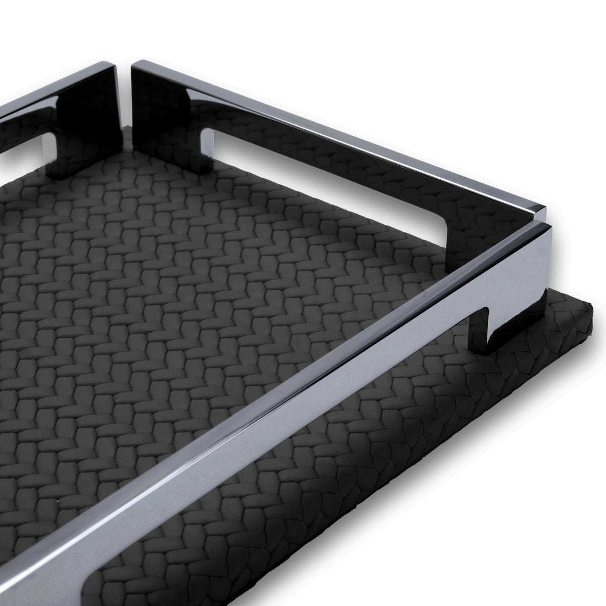 Low view along the long side of the black tray, polished steel rail and the notch cut into the 1 cm leather base