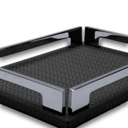 Two polished corner brackets meeting at the near corner of the black tray, woven-embossed full-grain leather floor behind