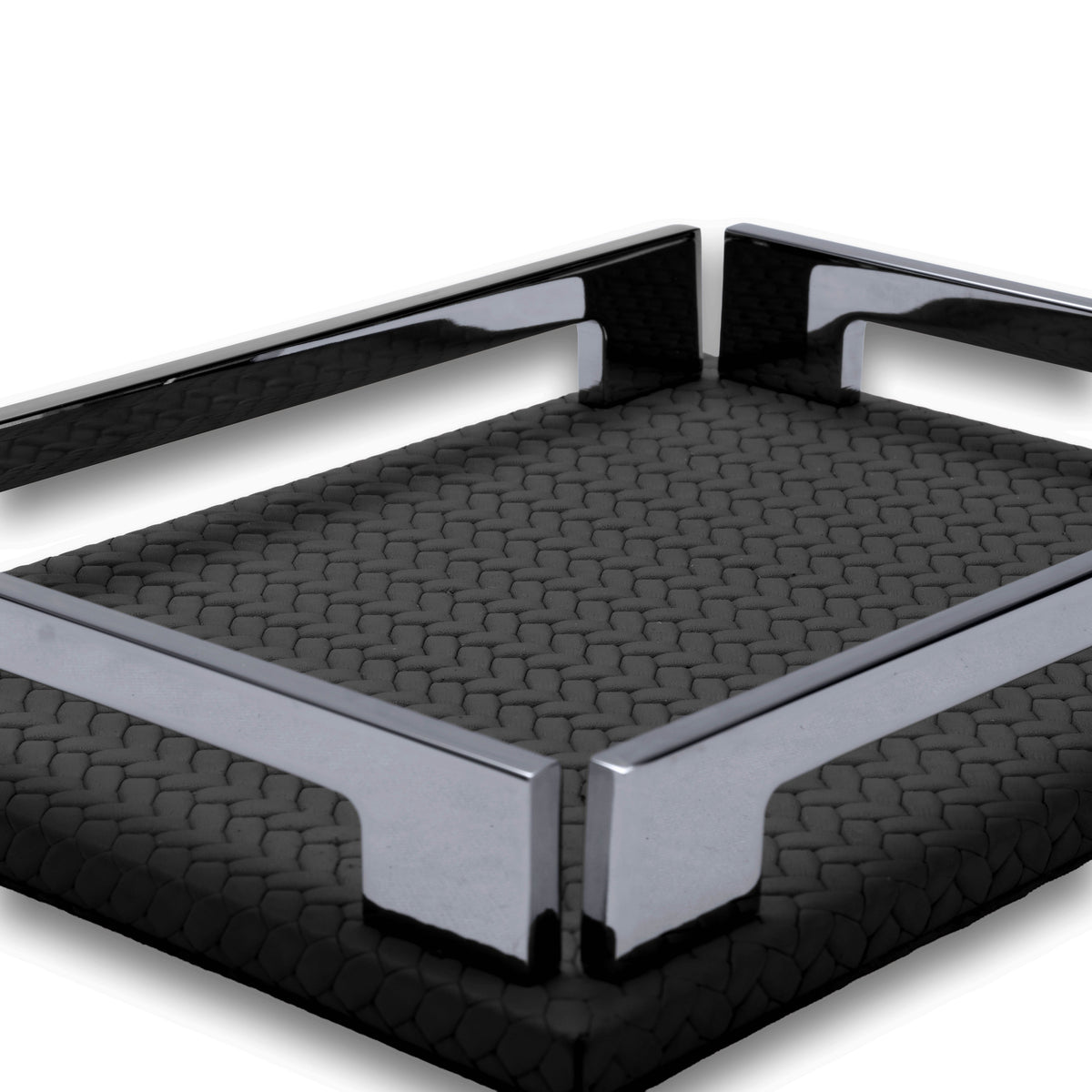 Two polished corner brackets meeting at the near corner of the black tray, woven-embossed full-grain leather floor behind