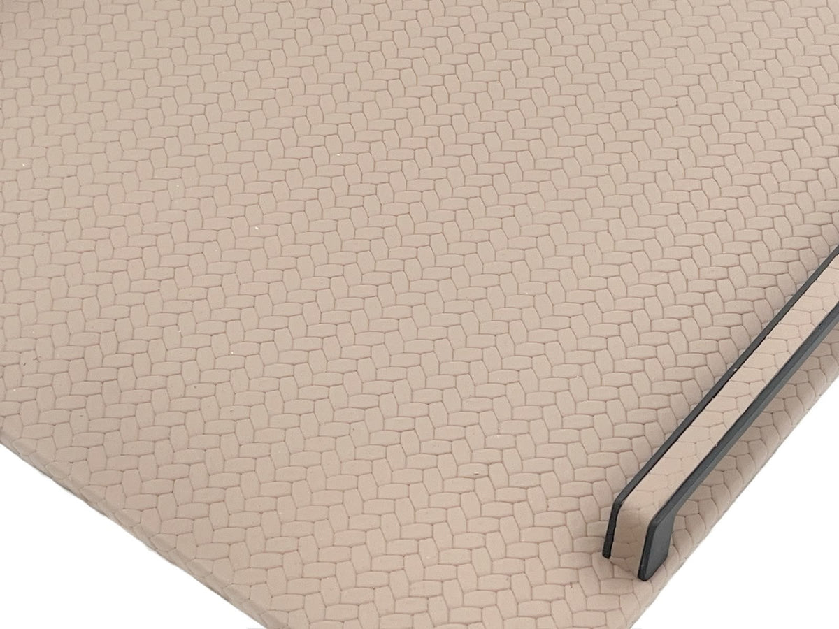 Close on a rounded corner, small honeycomb cells embossed across the leather and the panel edge showing its 1 cm profile