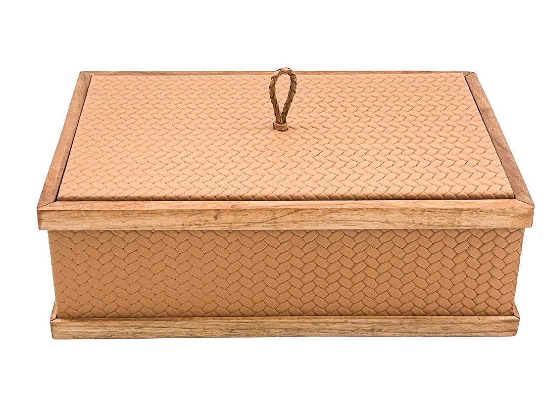 The closed box level from the front, its walnut plinth running the full 27 cm width beneath leather panels