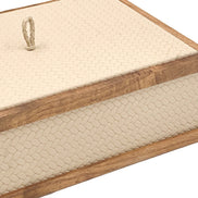Close on the cream box, a braided leather pull standing on the lid inside its walnut rail