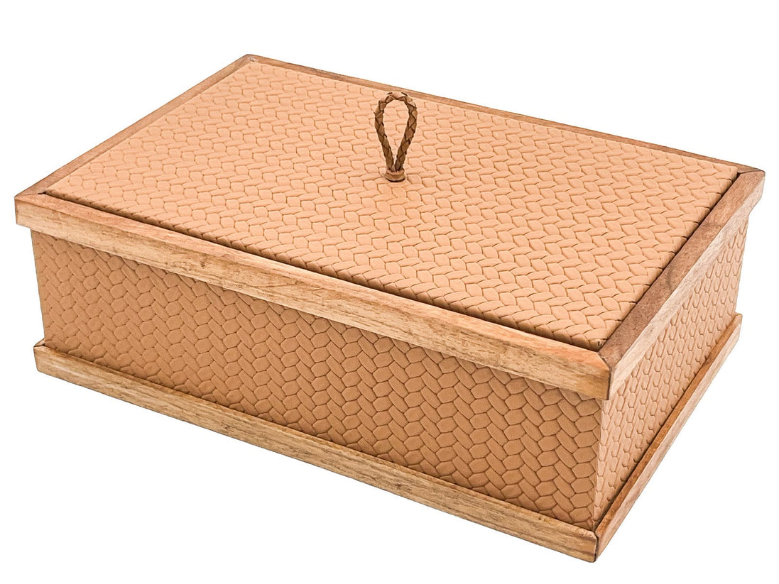 The 27 x 19 cm box seen from above and to one side, two leather faces meeting at a walnut-capped corner