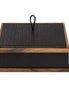 Black 26 × 26 cm box seen level, a plaited leather loop on the lid between walnut rails top and base