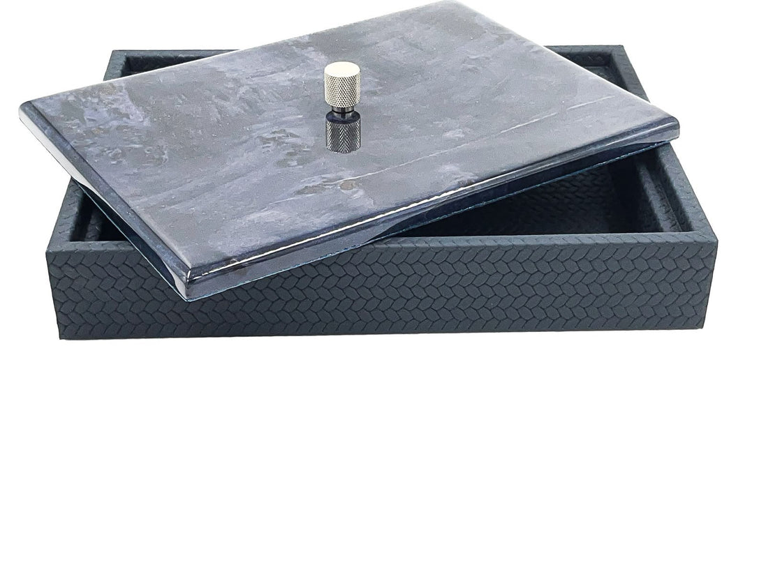 The large box shut with a dark marbled lacquer lid, 5.5 cm of woven leather wall beneath it