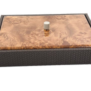 The box seen low from the front, its 5.5 cm leather side wall running the full 34 cm below a lacquered wood lid