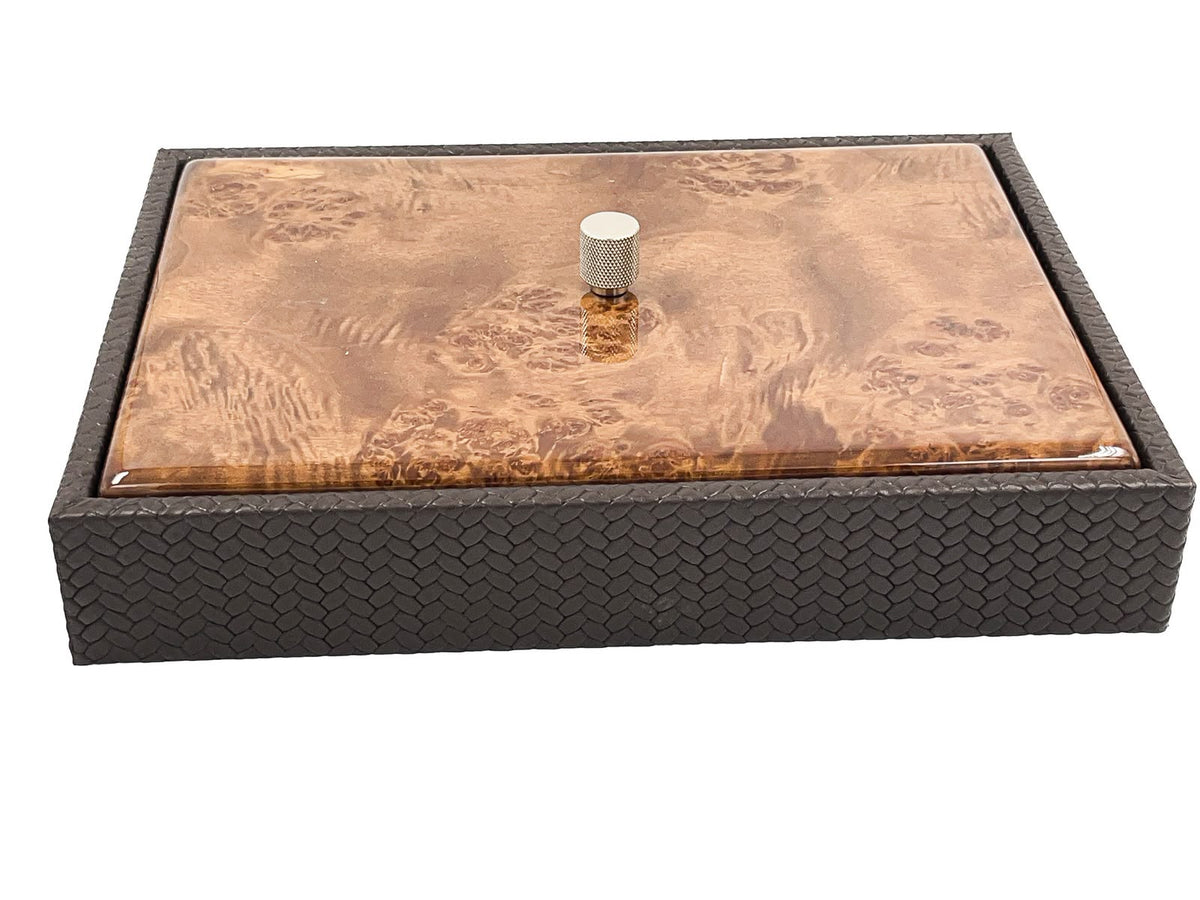 The box seen low from the front, its 5.5 cm leather side wall running the full 34 cm below a lacquered wood lid