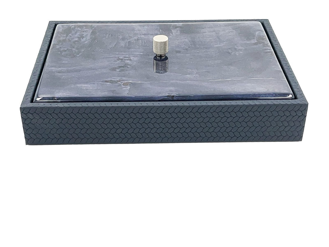 The lid seated flush inside a raised leather rim, the box wall below embossed in a fine chevron and 5.5 cm deep