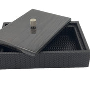 Black 27.5 × 20 cm box, the wood lid lifted clear at one corner over the woven leather interior