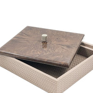 The 27 x 27 cm box with its mahogany lid slid aside, a knurled metal knob at the centre above the woven leather body