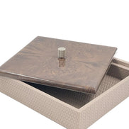 The 27 x 27 cm box with its mahogany lid slid aside, a knurled metal knob at the centre above the woven leather body
