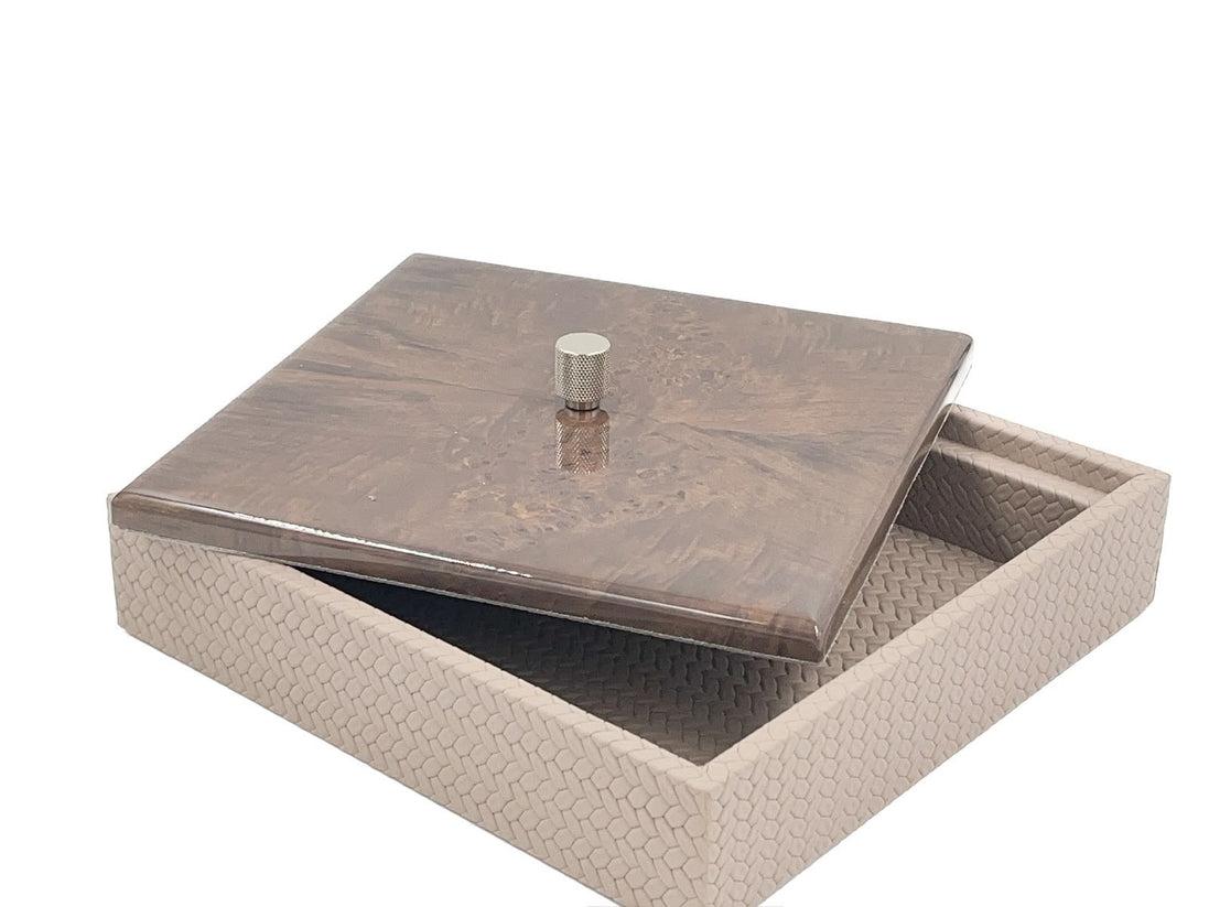 The 27 x 27 cm box with its mahogany lid slid aside, a knurled metal knob at the centre above the woven leather body