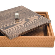 The box open, the mahogany lid tilted across one corner over the 5.5 cm woven leather sides