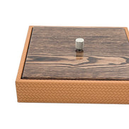 The 27 x 27 cm box closed at an angle, the knurled metal knob standing proud of the mahogany lid