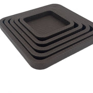 The five nested squares in brown leather from above and to the left, each wall stepping in toward the centre tray