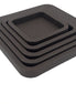The five nested squares in brown leather from above and to the left, each wall stepping in toward the centre tray