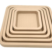 The nested set square on, the innermost tray's woven leather floor open at 22 cm across