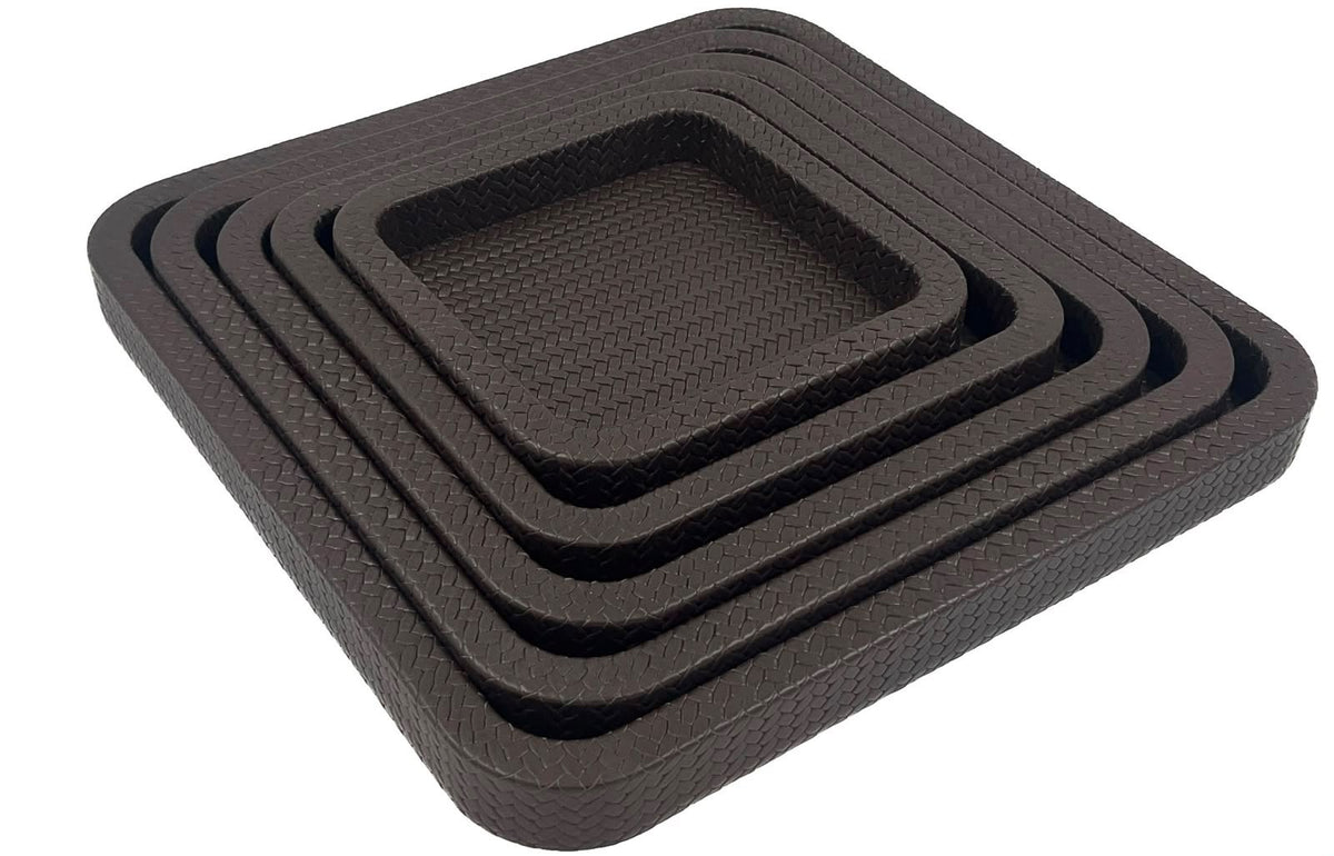 The set from above its right corner, the 42 cm outer tray framing four smaller brown leather squares