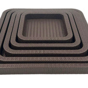 Front on and close, the innermost tray's basketweave floor sunk inside four brown leather rims