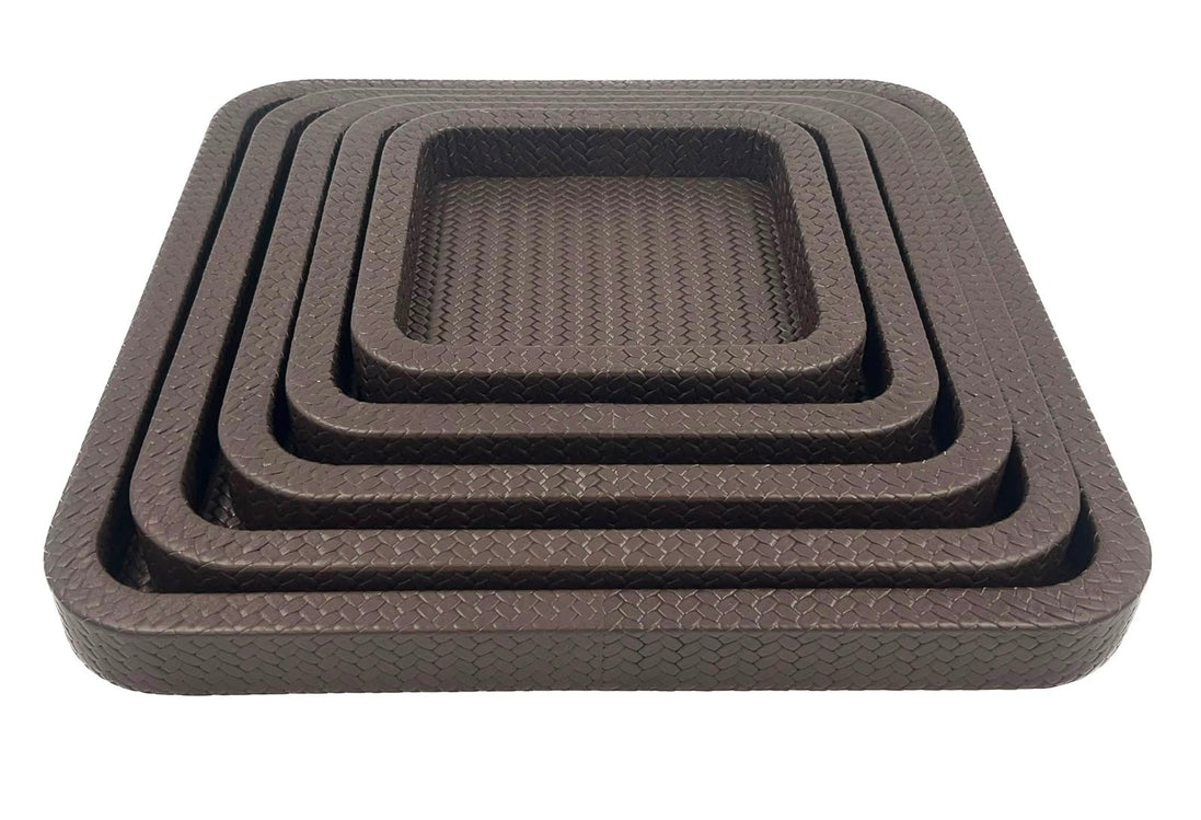 Front on and close, the innermost tray's basketweave floor sunk inside four brown leather rims