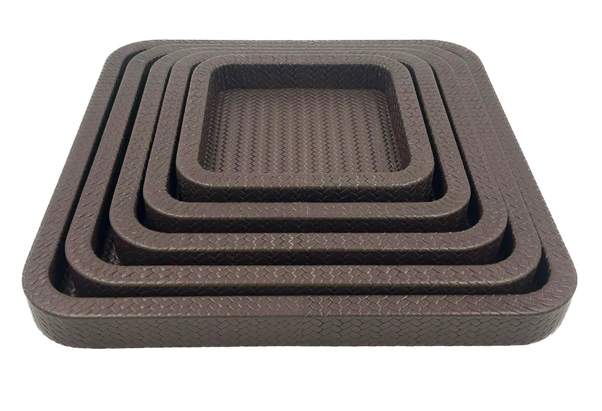 Front on and close, the innermost tray's basketweave floor sunk inside four brown leather rims