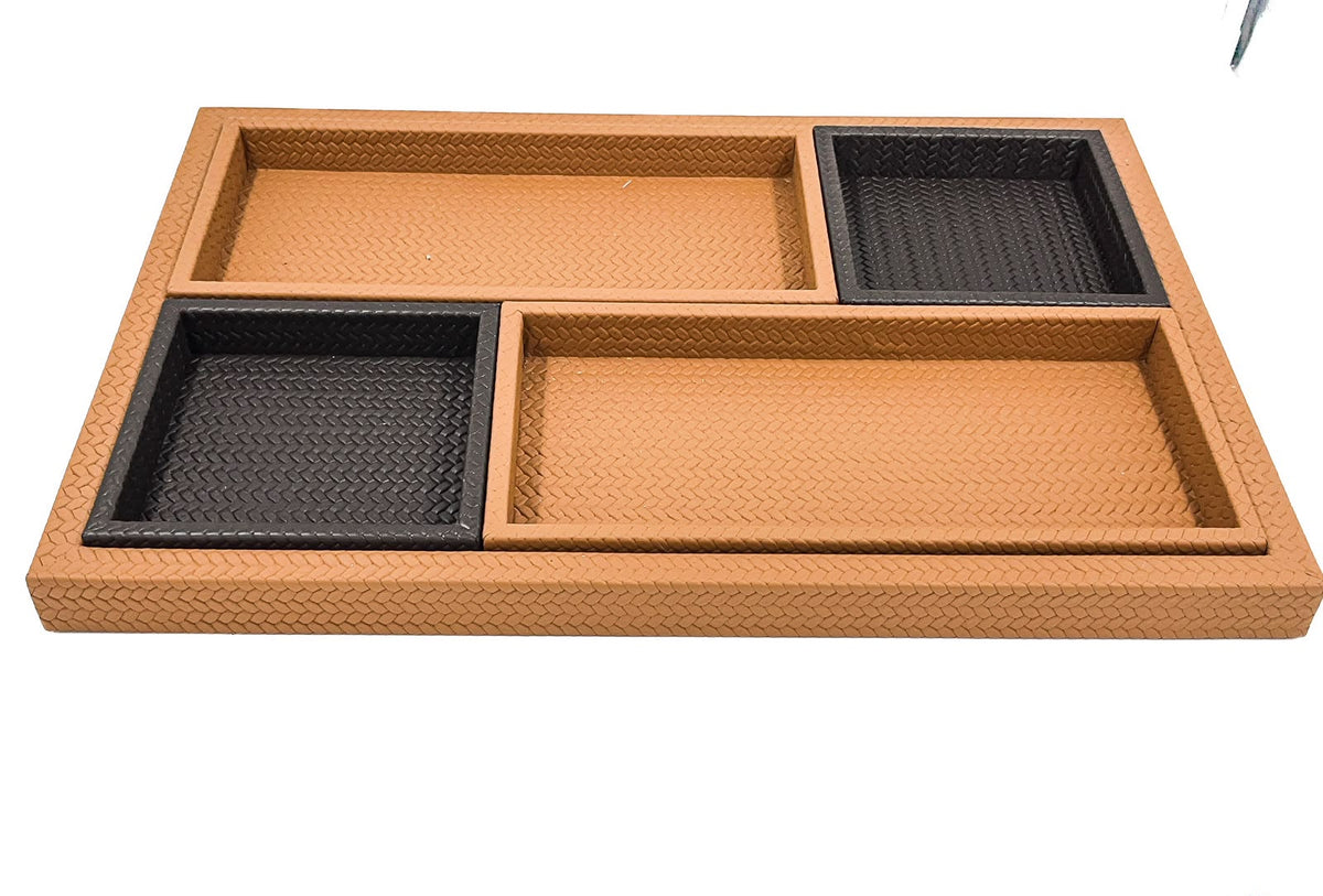 Four leather trays laid inside the base tray, two deep squares set diagonally against two long shallow ones