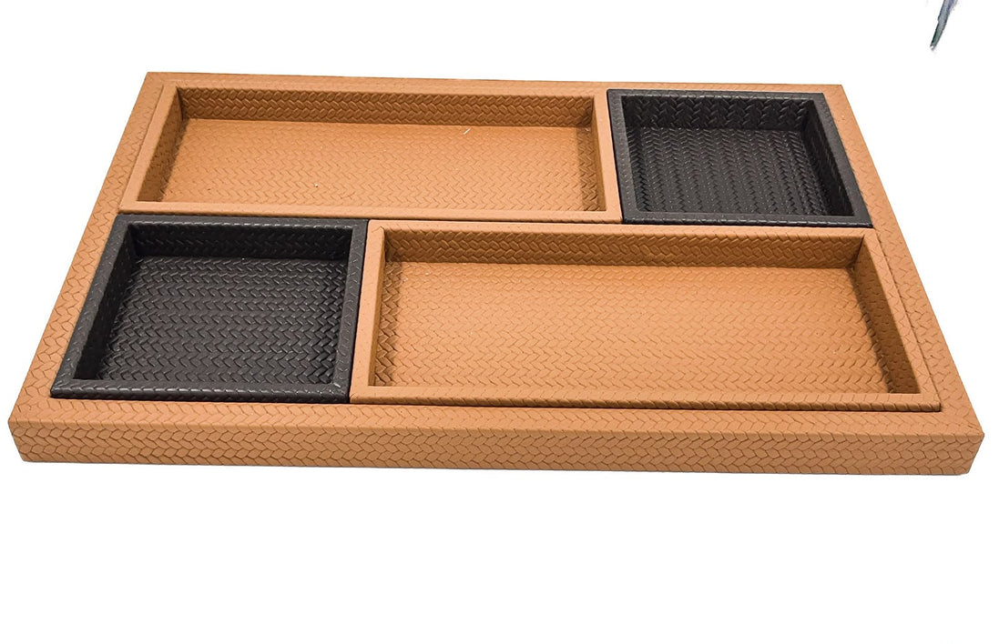 The set from above, the woven leather floor of the base tray still open along one side beyond the four inner trays