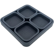 Four small trays seated in the 37 x 37 cm base tray, their walls standing level inside its 3.5 cm rim