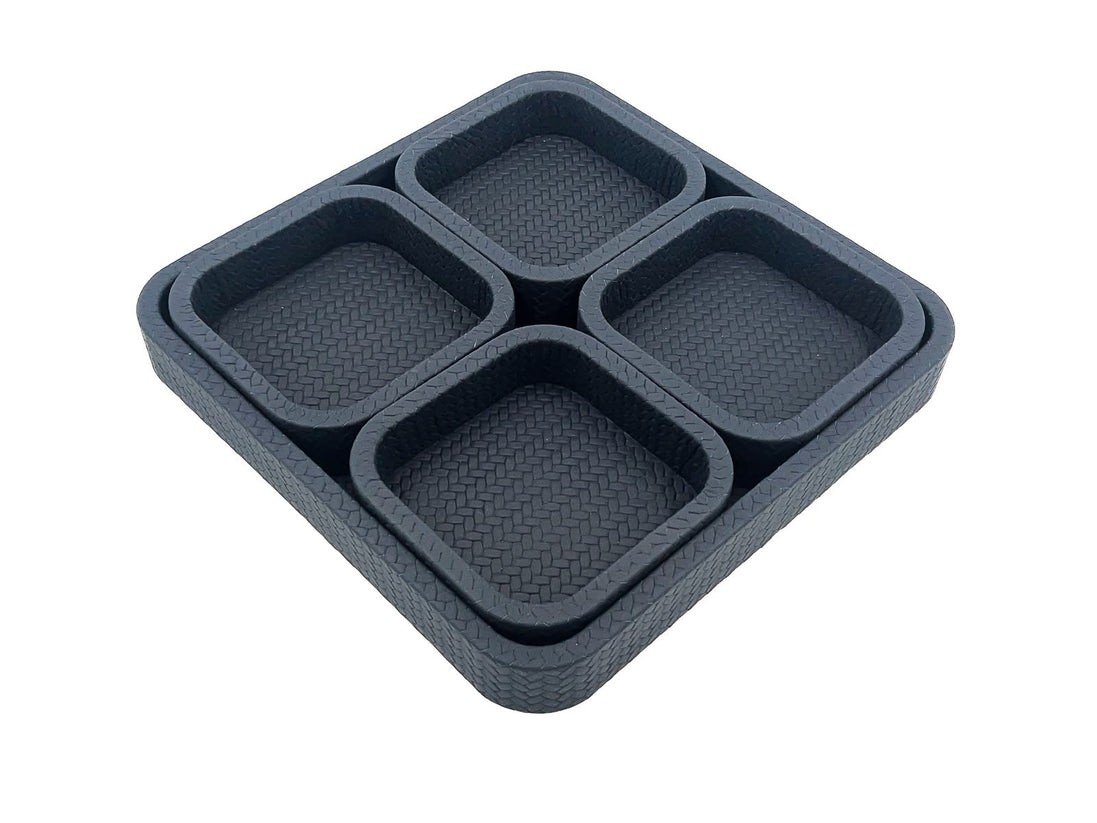 Four small trays seated in the 37 x 37 cm base tray, their walls standing level inside its 3.5 cm rim