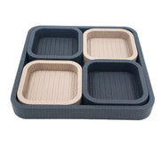 The 37 x 37 cm tray seen level, four compartments inside it alternating dark and pale leather
