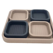 Looking across the pale base tray, its four 3.5 cm leather compartments lifted clear of the woven floor