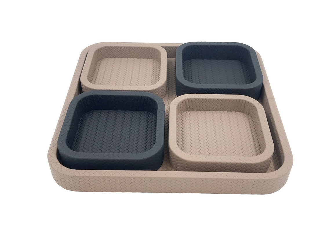 Looking across the pale base tray, its four 3.5 cm leather compartments lifted clear of the woven floor