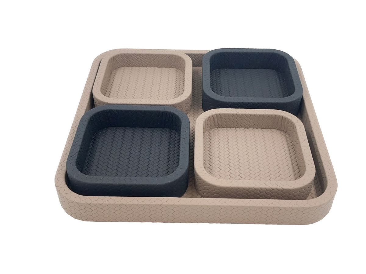 Looking across the pale base tray, its four 3.5 cm leather compartments lifted clear of the woven floor
